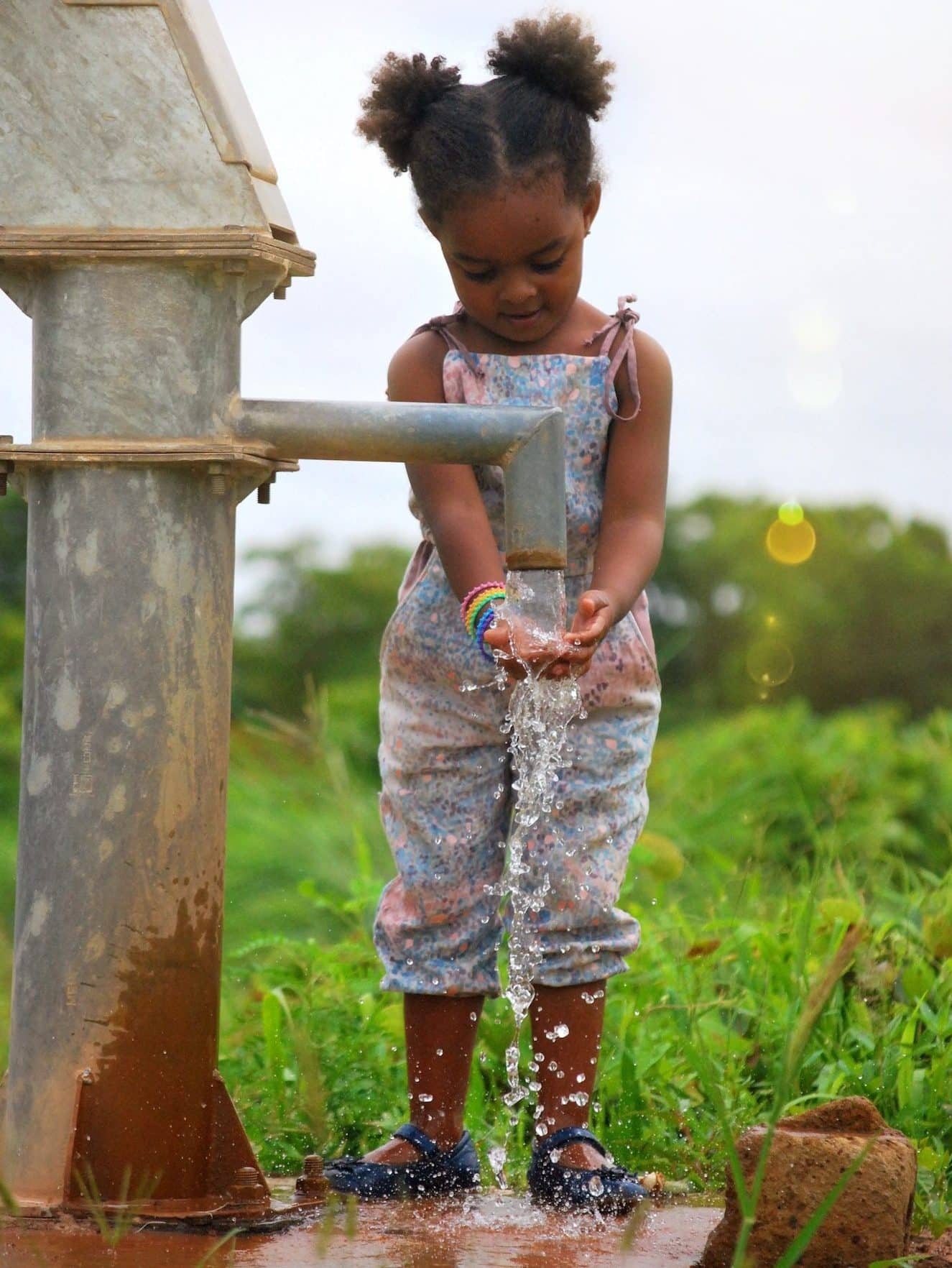 girl-washing-her-hands-at-a-water-well-in-burkina-faso-africa-e1659542851666.jpg